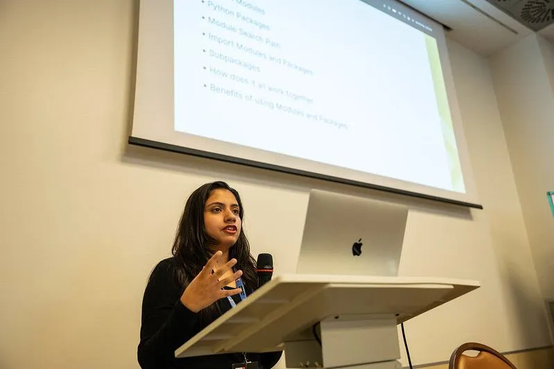 Swastika speaking at the podium at PyCon Italy