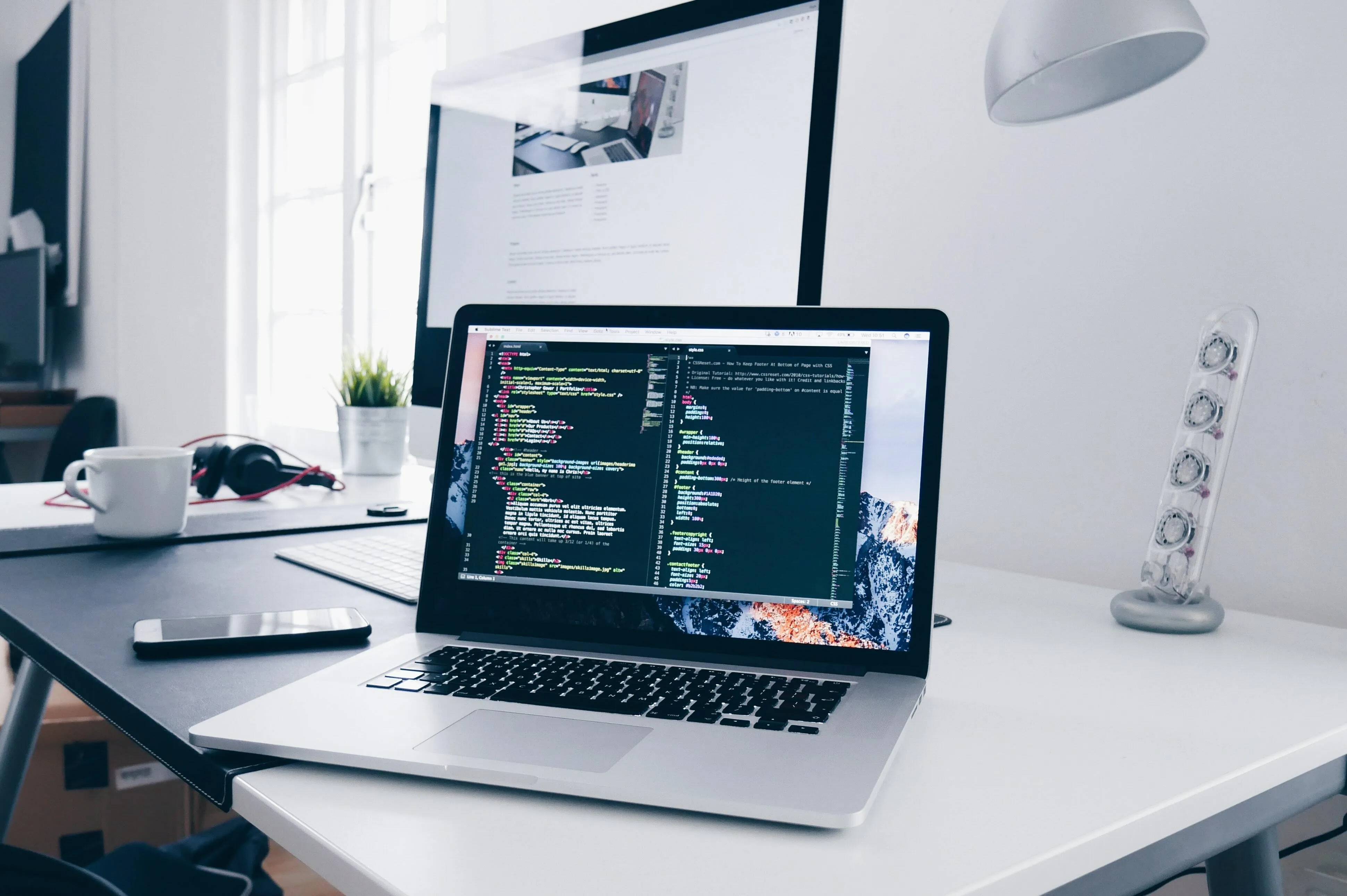 A laptop with code on screen on a desk